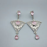 A pair of gothic punk metal earrings, pink stone plating, distressed men's and ladies' party engagement jewelry